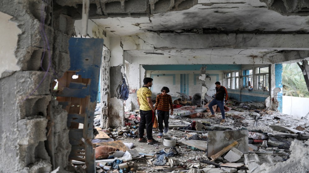 فلسطينيون يتفقدون موقع غارة إسرائيلية على مدرسة تابعة للأونروا تؤوي النازحين في مخيم النصيرات وسط قطاع غزة. 6 حزيران، 2024. (رويترز)